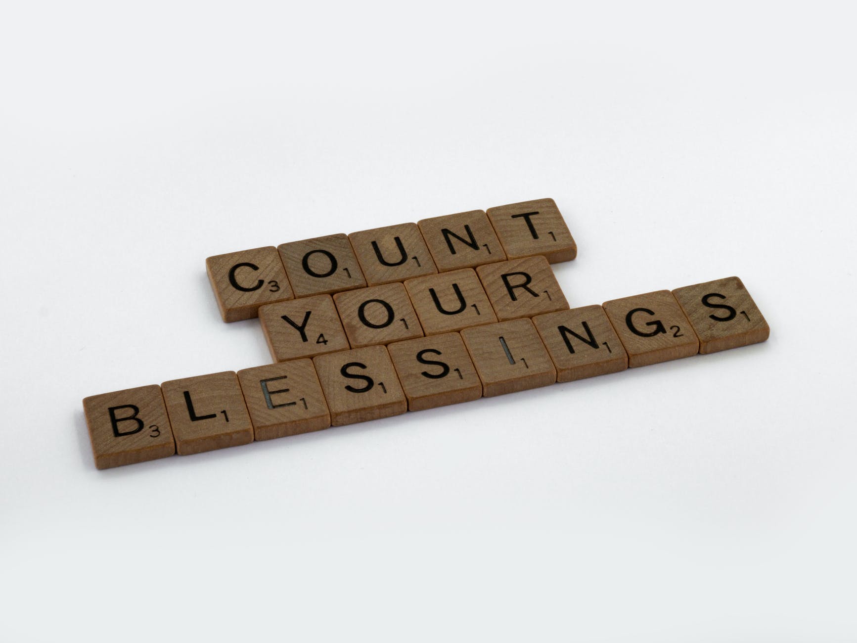 wooden letter tiles on white surface